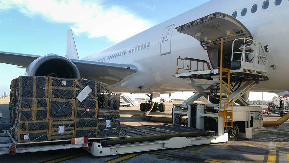 AdobeStock_231839148 Process of cargo handling. Parcels loading with high loader